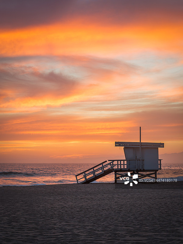 日落时分海滩上的救生员塔图片素材