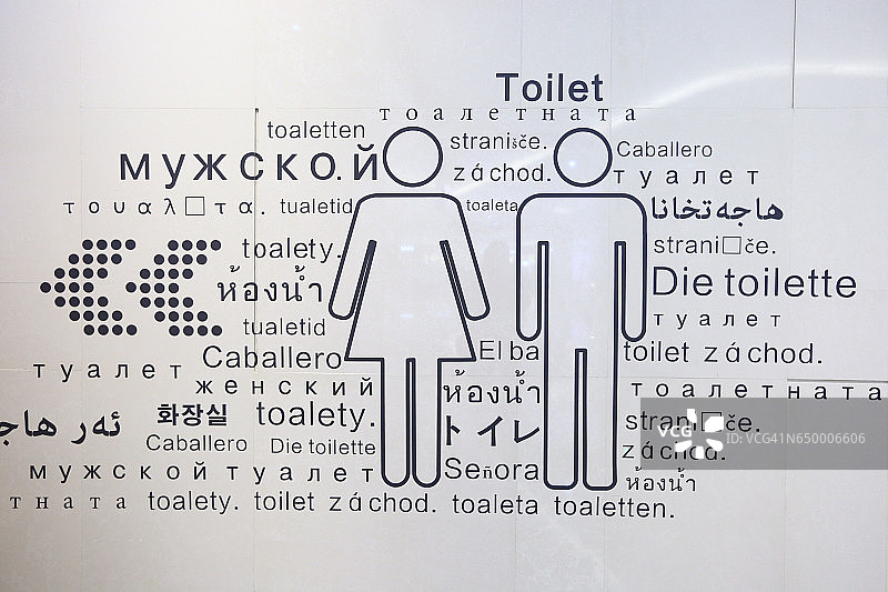 厕所墙上有多民族语言的男女标识图片素材