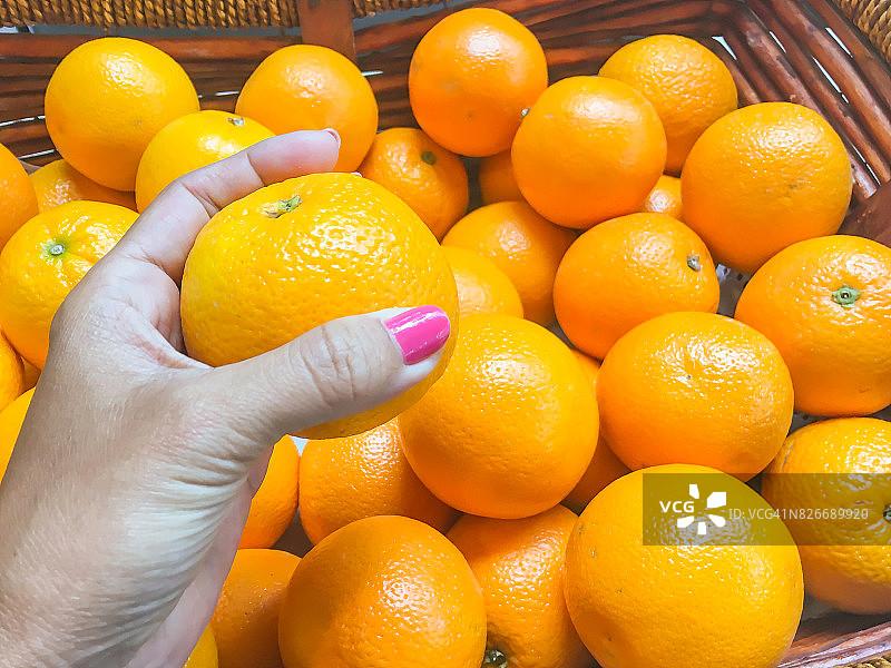 女性手里拿着新鲜的橘子水果图片素材