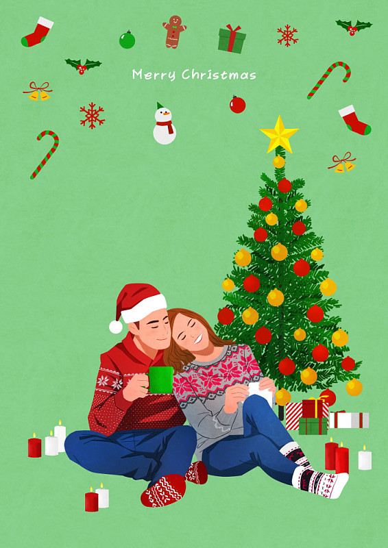 一对夫妇在圣诞树前喝热茶图片下载