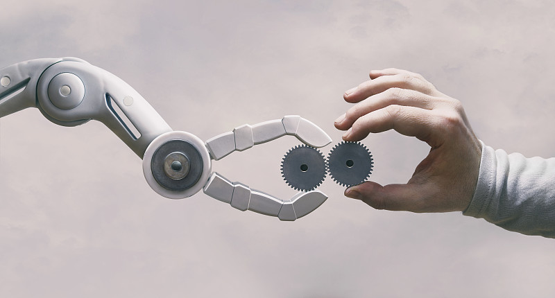 机器人和人的手与齿轮图片素材
