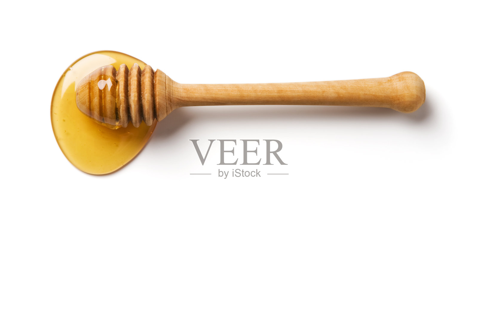 木材蜂蜜勺蘸蜂蜜照片摄影图片