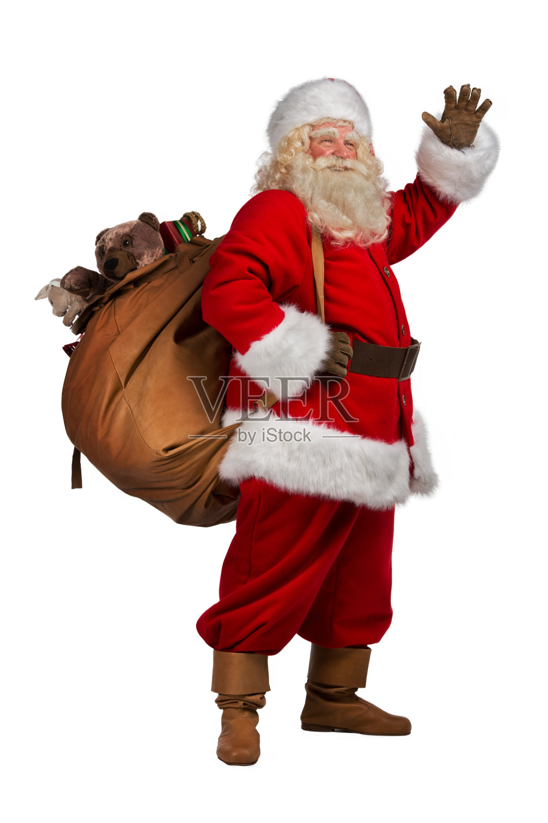 圣诞老人背着装满礼物的大袋子照片摄影图片