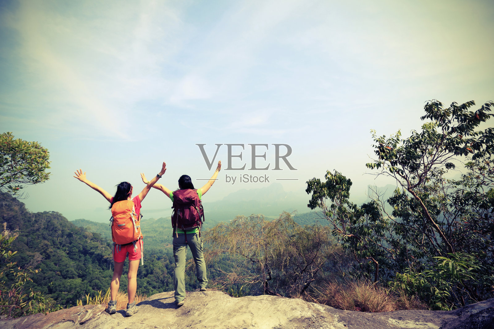 两个成功徒步旅行的朋友在山顶欣赏风景照片摄影图片