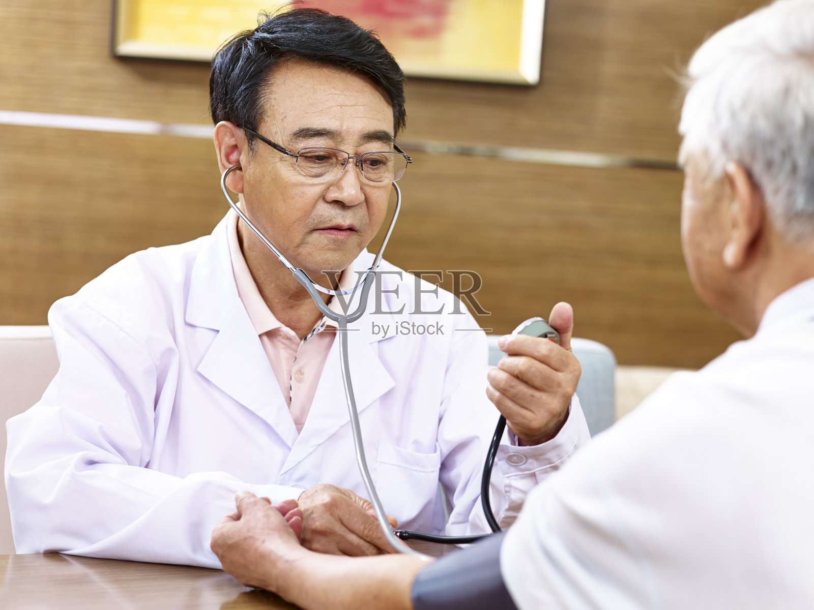 亚洲医生检查血压的一个老病人照片摄影图片