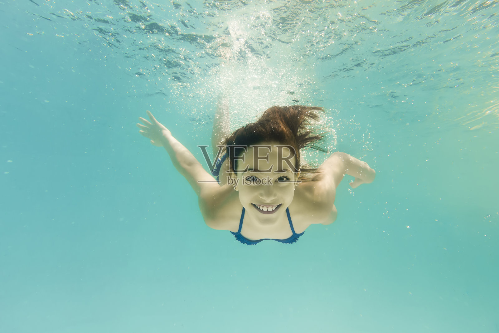 8岁女孩微笑着潜入水下照片摄影图片