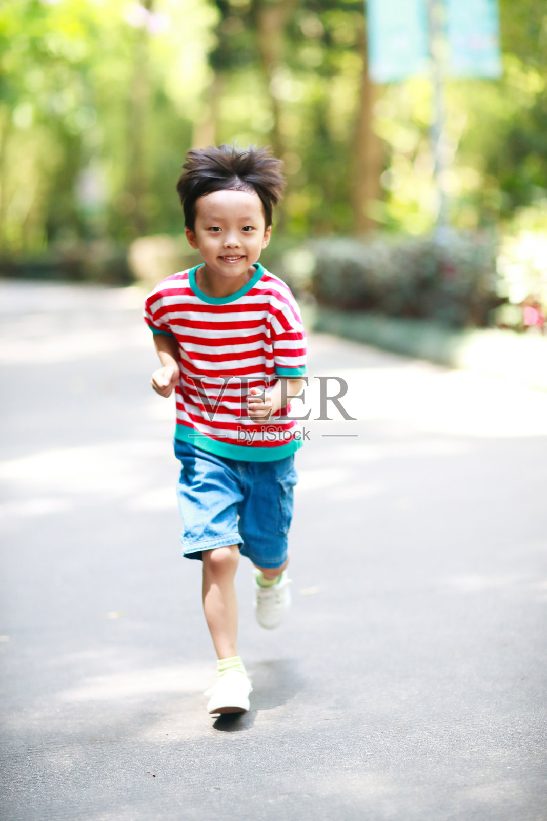 小男孩在公园里跑步照片摄影图片