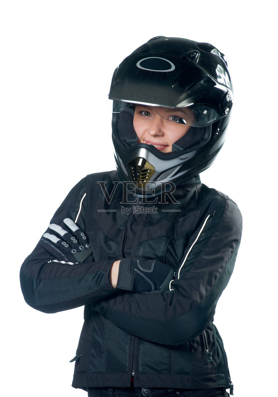 年轻的美女在摩托车服装和头盔摆姿势照片摄影图片