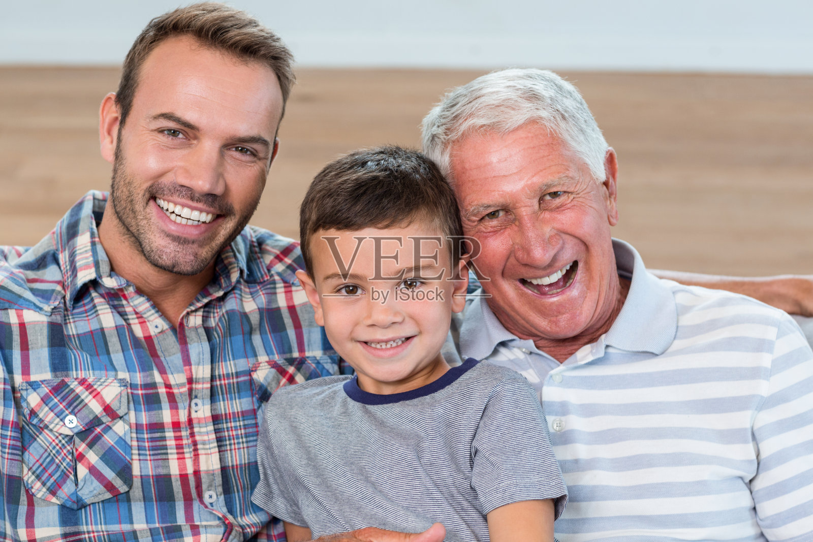 父亲，儿子和孙子坐在沙发上照片摄影图片