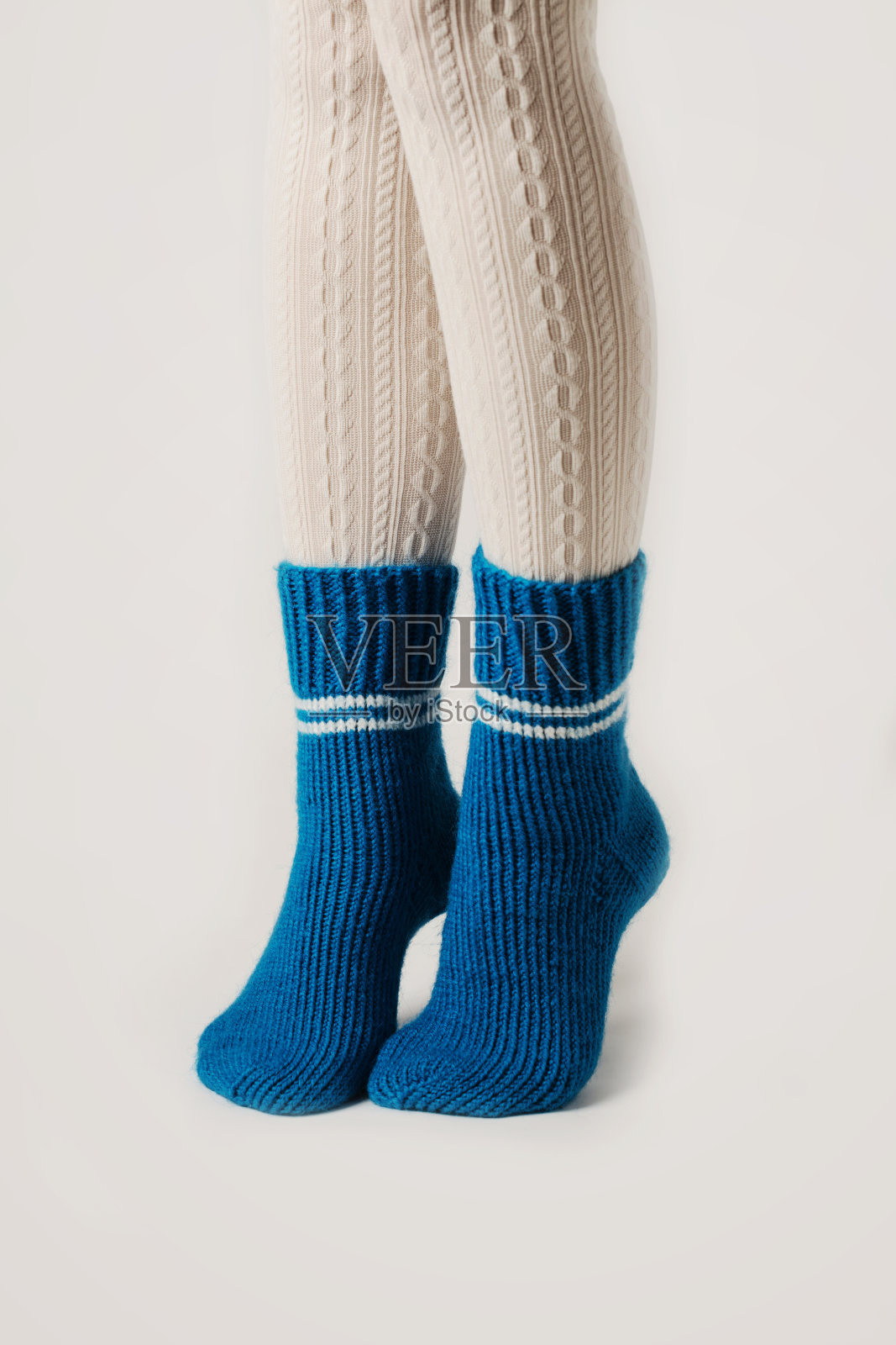 女腿在白色长袜和蓝色针织短袜。照片摄影图片