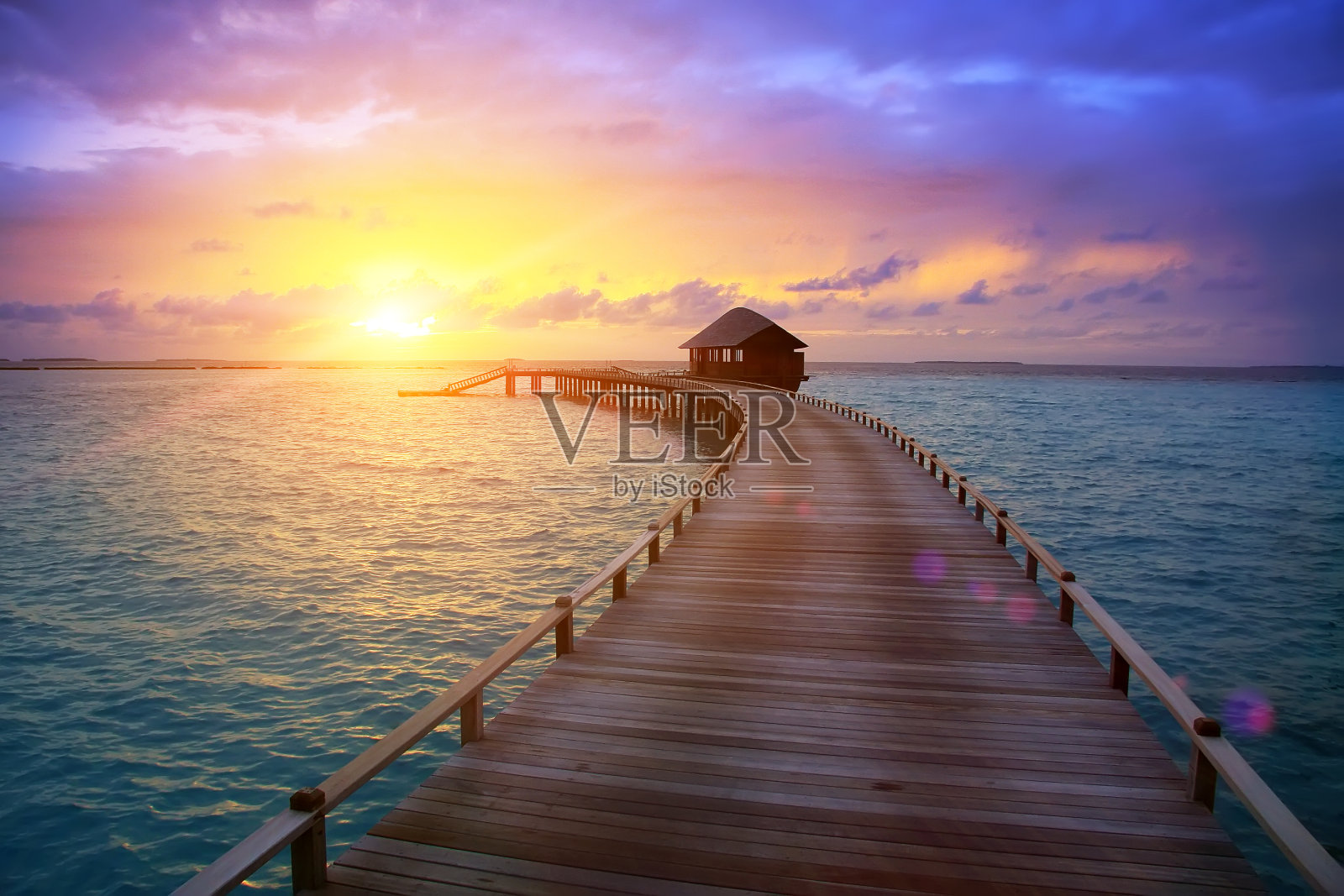 日落时分，从岛上到水上小屋的木路。马尔代夫。照片摄影图片