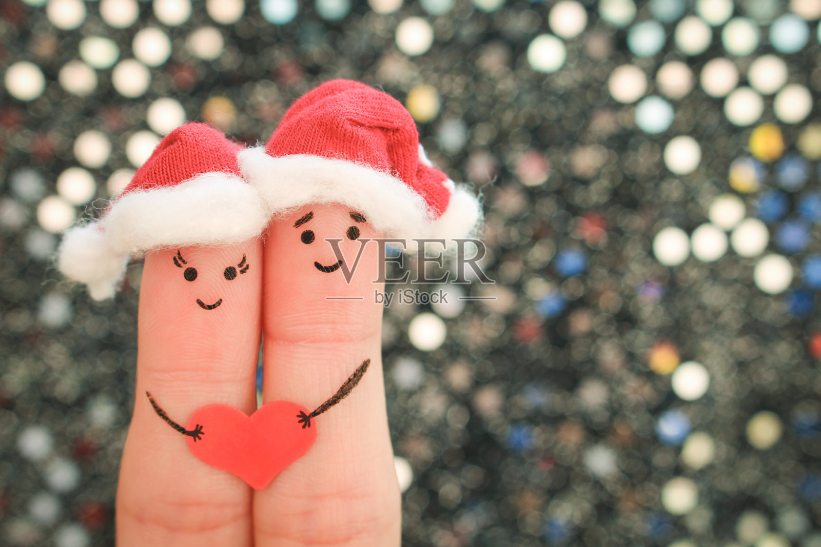 手指艺术的夫妇庆祝圣诞节在新年帽子。健美的形象。照片摄影图片
