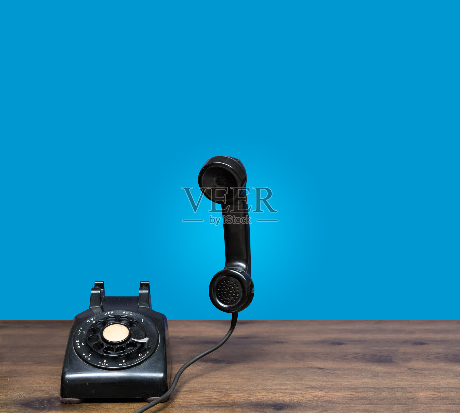 老式的旋转拨号电话放在有复印空间的木桌上照片摄影图片