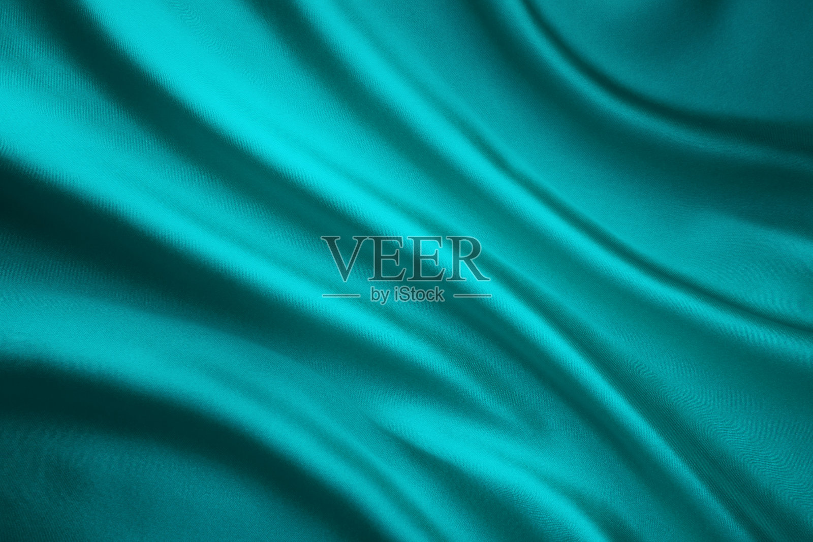 织物摇摆丝绸背景，蓝绿色缎子布，波浪形状照片摄影图片