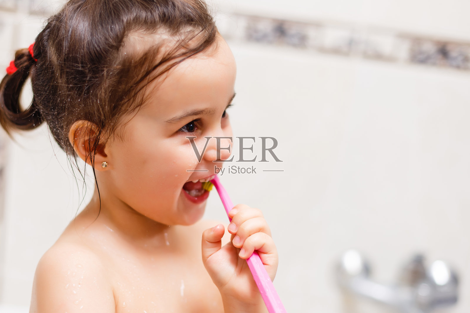 孩子正在用蓝色的牙刷刷牙照片摄影图片