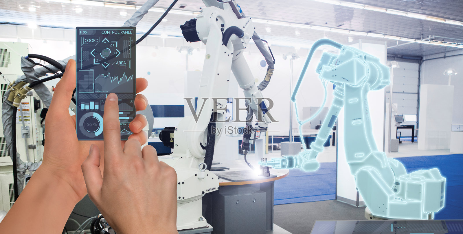 工程师使用未来透明智能手机在智能工厂控制机器人照片摄影图片