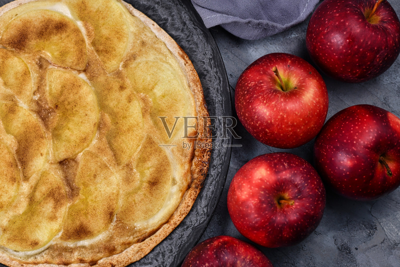 来自德法接壤的阿尔萨斯地区的“火馅饼”或“火馅饼”，类似于薄披萨，上面覆盖了苹果片、糖和肉桂照片摄影图片