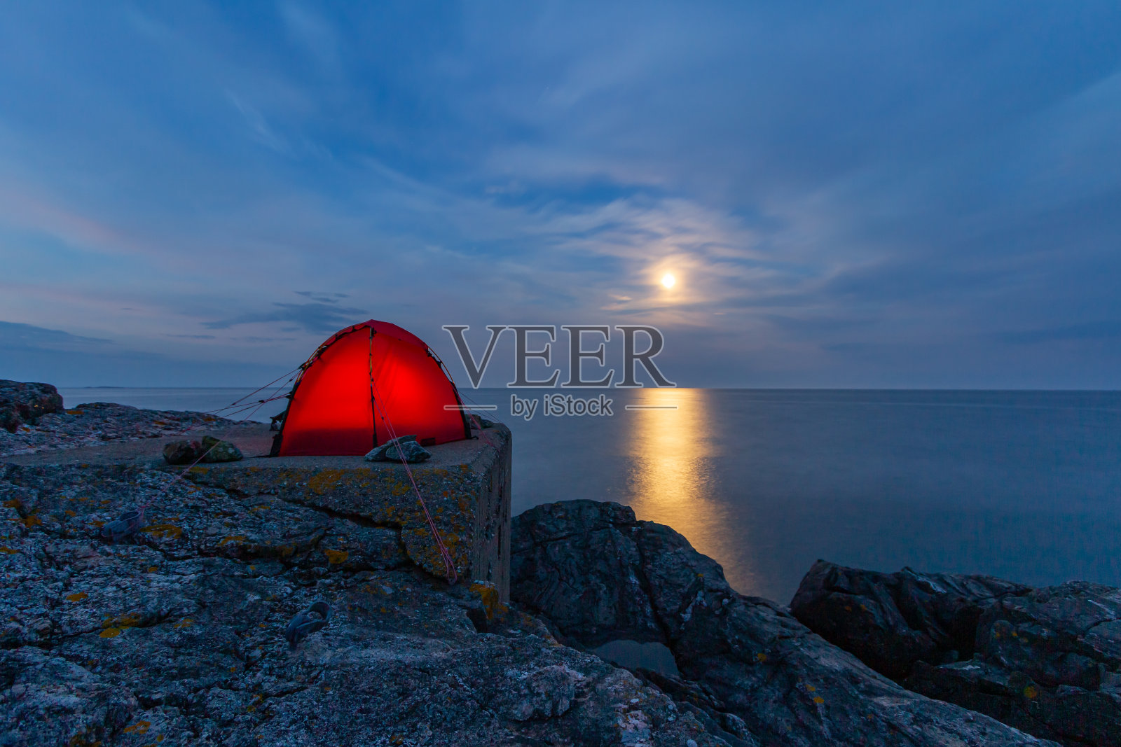 在瑞典Nynäshamn群岛的月光下，岩石上搭帐篷照片摄影图片