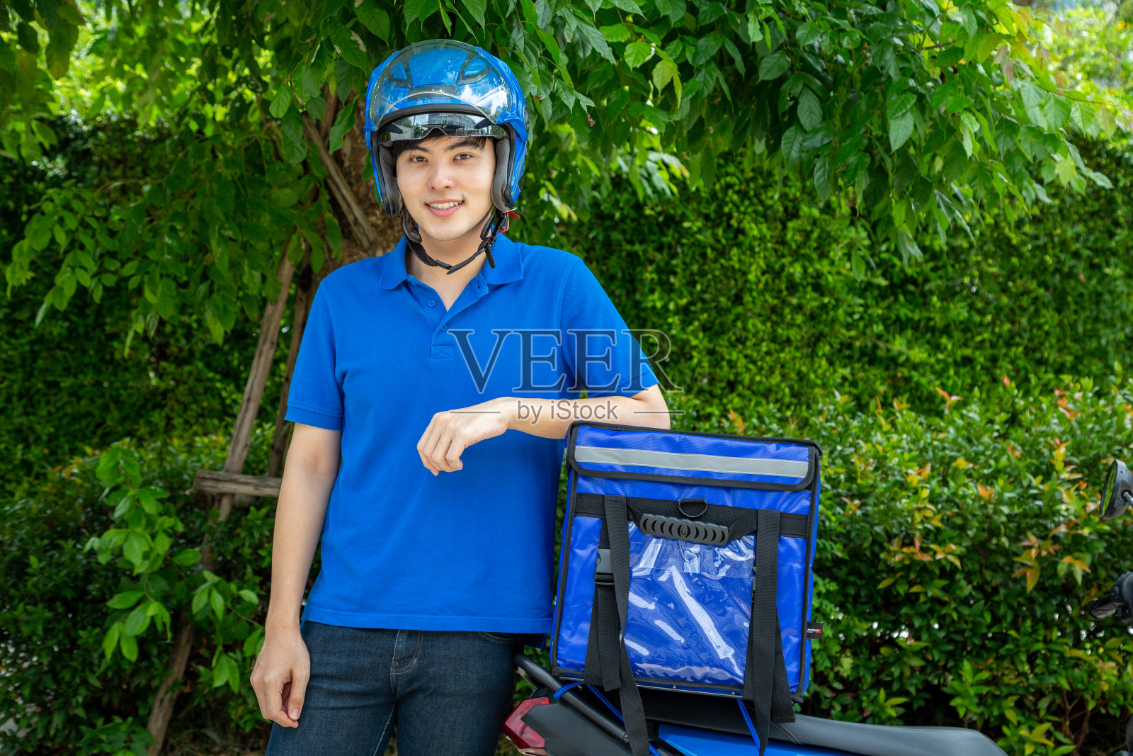 年轻亚洲男人用快递箱，摩托车送餐快递服务理念照片摄影图片