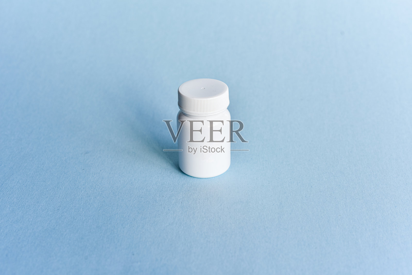 白色容器中的小瓶药丸/维生素照片摄影图片