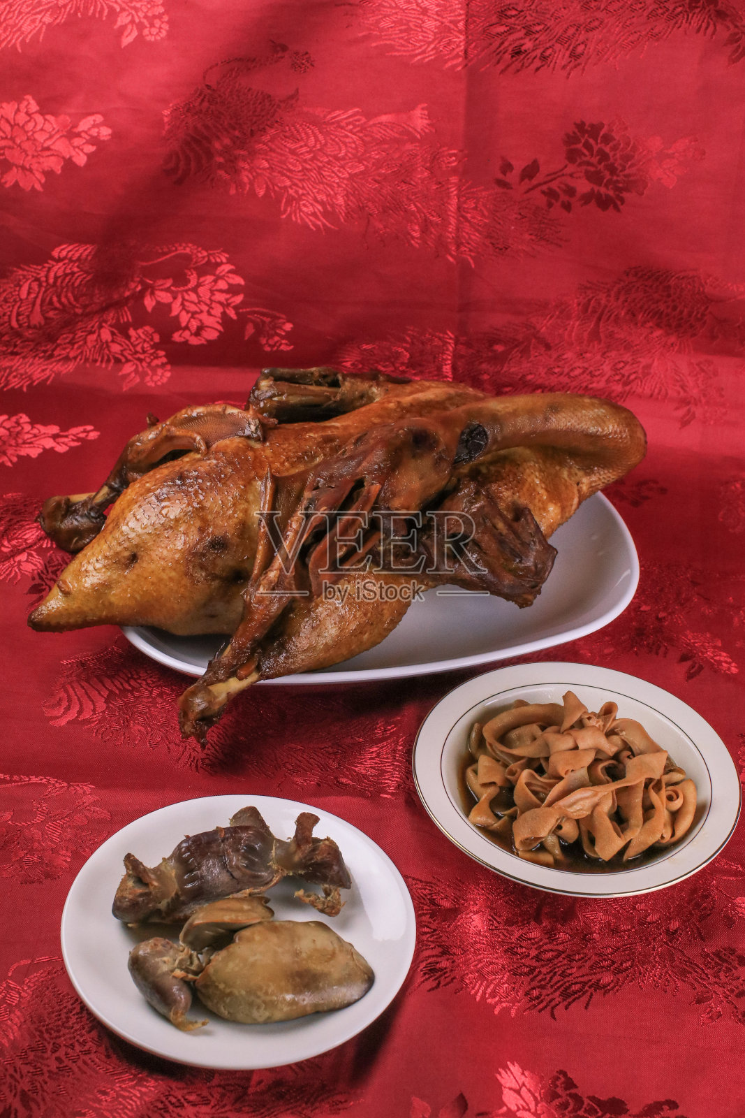 美味的金棕色鸭或清蒸鸭在Paloe或Lou mei酱(泰国名字是Pedpalow)，供中国新年祭祀的红色背景。照片摄影图片