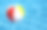 一个浮在蓝色水池里的沙滩球素材图片