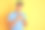 年轻的印度男子穿着蓝色马球站在孤立的黄色背景微笑，双手放在胸前，闭上眼睛和感激的手势在脸上。健康的概念。素材图片