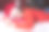 一个年轻的白人女孩戴着圣诞帽和红毛衣睡在床上，抱着一个红色的礼品盒的肖像素材图片